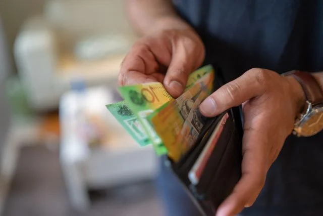 A man taking out money from his wallet.