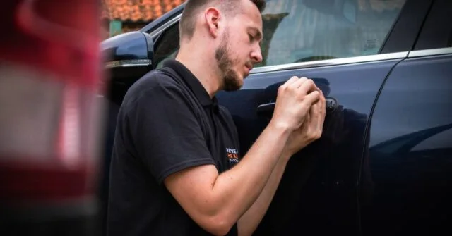 A professional locksmith picking a broken car key.