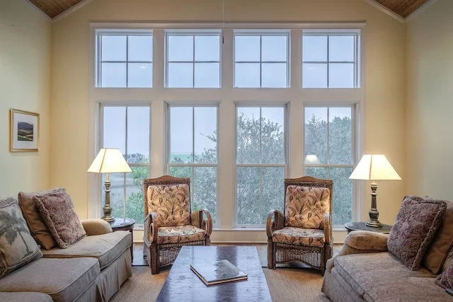 White painted house with big and wide windows.