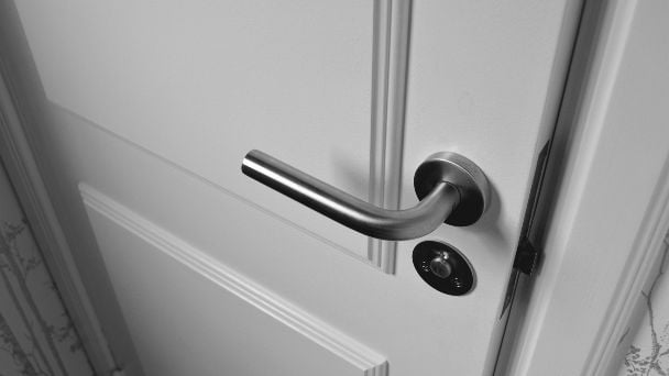 A closing door with a lever handle.